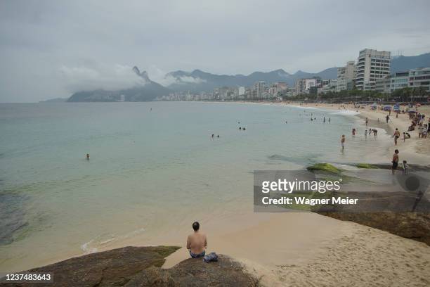 Man is seen on Arpoador this afternoon on December 31, 2021 in Rio de Janeiro, Brazil. Due to the spread of the Omicron variant and the surge of...