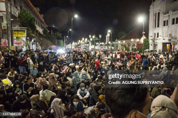 Revellers gather at the town square to usher during the New Year's eve festivities in Yogyakarta on January 1, 2022.