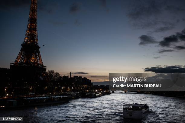 Boat cruises on the river Seine past the Eiffel Tower, on December 31, 2021 in Paris.