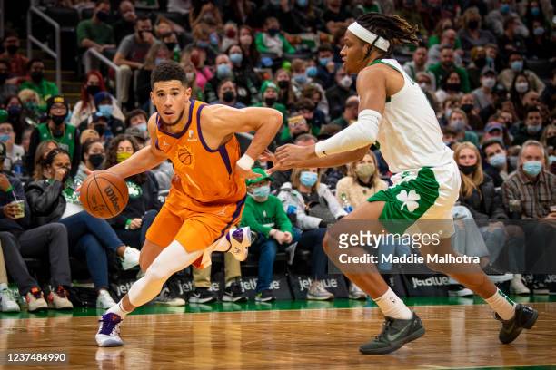 Devin Booker of the Phoenix Suns drives to the basket against Romeo Langford of the Boston Celtics during the second half of a game at TD Garden on...