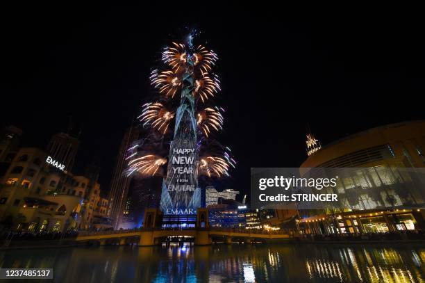 Picture taken on December 31, 2021 shows fireworks erupting from the Burj Khalifa in the Gulf emirate of Dubai as part of the New Year's festivities....