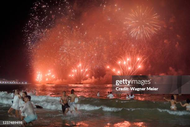 Revelers enjoy the fireworks and celebrate the New Years on Copacabana beach on January 01, 2022 in Rio de Janeiro, Brazil. Due to the spread of the...