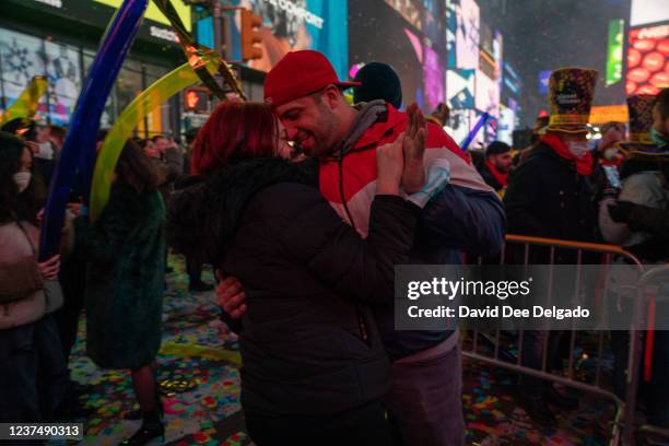 Couple kisses at Times Square during New Year celebrations on January 1, 2022 in New York City. Despite record numbers of COVID-19 cases across the...