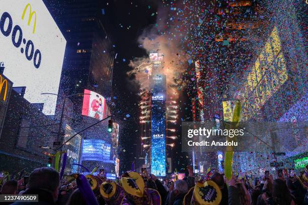 Confetti flies in the air as people gather for the annual ball drop to celebrate the New Year at Times Square in New York City on January 1, 2022.