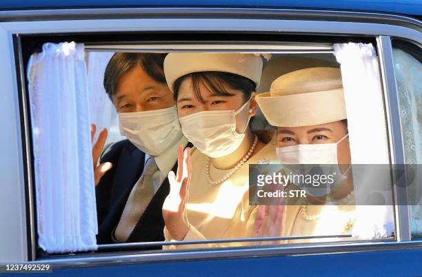Japan's Emperor Naruhito , Empress Masako and their daughter Princess Aiko wave at members of the media from a car as they visit the former emperor...