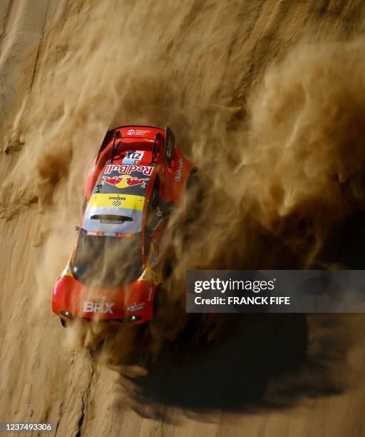 Red Bull's French driver Sebastien Loeb and co-driver Fabian Lurquin of Belgium compete during the Stage 1A of the Dakar Rally 2022 between Jeddah...