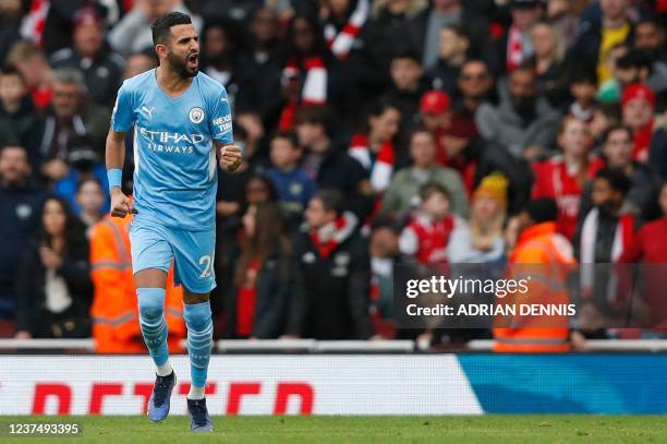 Manchester City's Algerian midfielder Riyad Mahrez celebrates after scoring the equalising goal from the penalty spot during the English Premier...