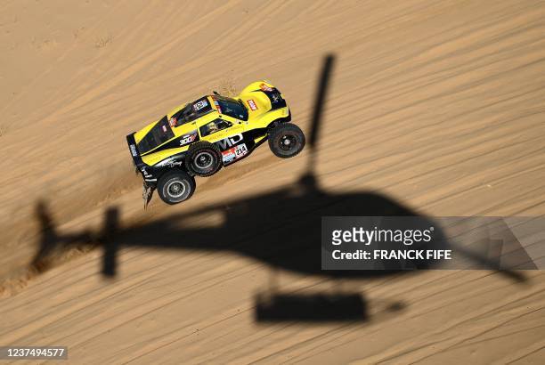 Mini's Driver Yasir Seaidan of Saudi Arabia and co-driver Alexey Kuzmich of Russia compete during Stage 1A of the Dakar 2022 rally between the Saudi...