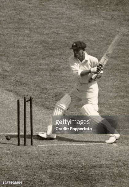 World-record crowd of 63,993 cricket fans watch Australian cricketer Don Bradman out first ball, bowled by Bill Bowes of England, during the first...