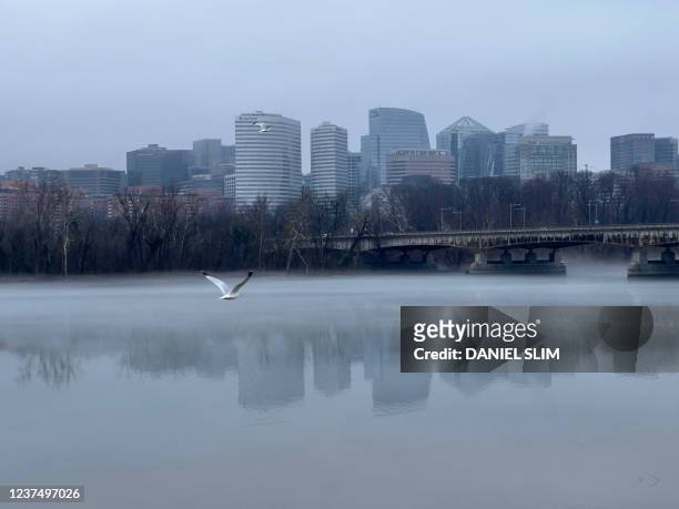 White fog rises over the Potomac river seen on Memorial bridge between Washington DC and Arlington Virginia on January 1st, 2021.