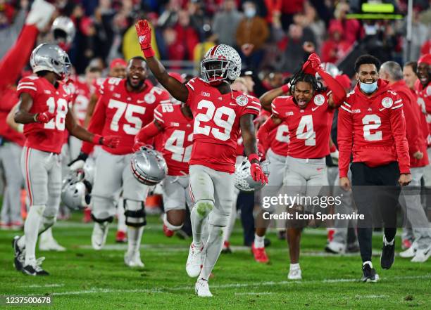 Ohio State Buckeyes cornerback Denzel Burke and his teammates celebrate on the field after the Buckeyes defeated the Utah Utes 48 to 45 to become the...