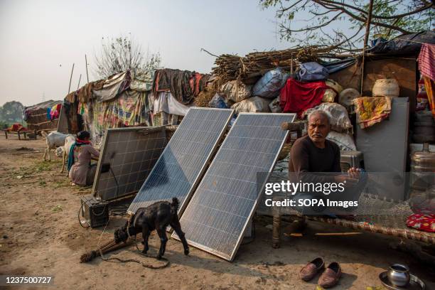 Solar panels kept under sunlight in front of temporary huts, in yamuna flood area. The recently concluded COP26 UN Climate Change Conference,...