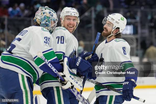 Thatcher Demko of the Vancouver Canucks, Tanner Pearson and Conor Garland celebrate after the 5-2 win against the Seattle Kraken at Climate Pledge...