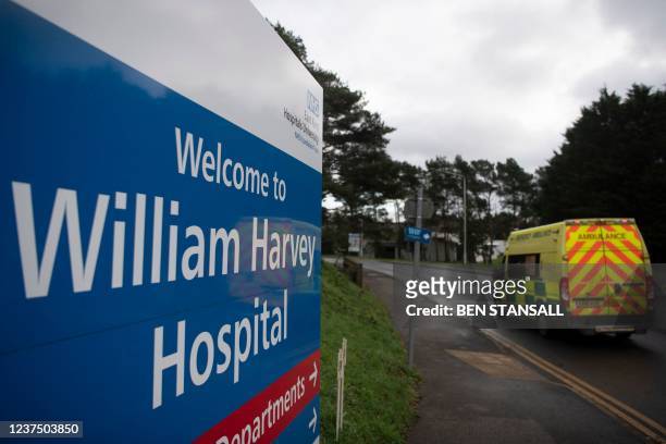 An ambulance passes a sign welcoming people to The William Harvey Hospital, where a temporary field hospital, a Nightingale 'surge hub', is being...