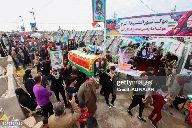 Mourners, including members of Iraq's al-Hashed al-Shaabi ex-paramilitary alliance, take part in a symbolic funeral procession towards the tomb of...