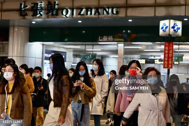 Commuters exit a Mass Rapid Transport station in Xindian in New Taipei City on January 3 after a strong earthquake struck off the coast of eastern...