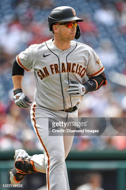 Buster Posey of the San Francisco Giants runs to first base after hitting a single during the sixth inning of game one of a doubleheader against the...