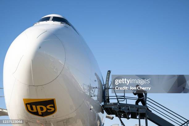 Pilot runs toward the flight deck of a Boeing 747 at UPS Worldport on January 3, 2022 in Louisville, Kentucky. UPS will handle the movement of...