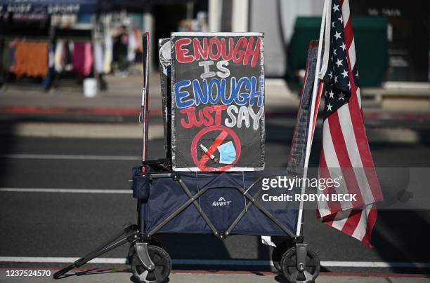 Display of a face mask and syringe with a circle and red line through it are seen at a protest against Covid-19 vaccine mandates for students, in...