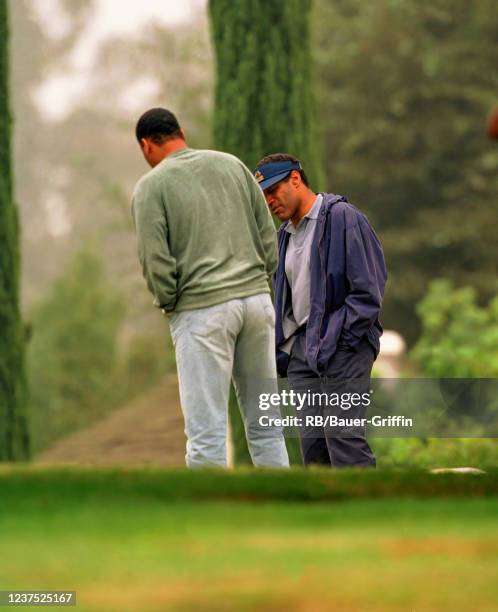 Cowlings and O.J. Simpson are seen at the grave of Nicole Brown Simpson on October 22, 1995 in Los Angeles, California.