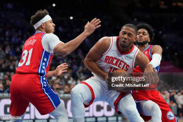 Eric Gordon of the Houston Rockets drives to the basket against Seth Curry and Isaiah Joe of the Philadelphia 76ers in the second half at the Wells...