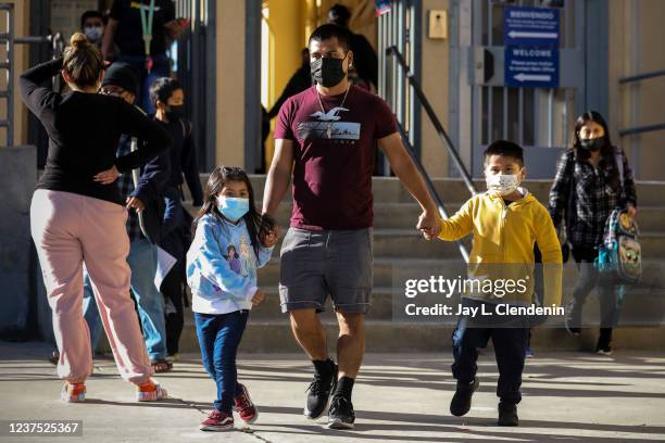 Long Beach, CA At the end of the school day, Felipe Martinez leaves through the front gates at John G. Whittier School with daughter Julissa left and...