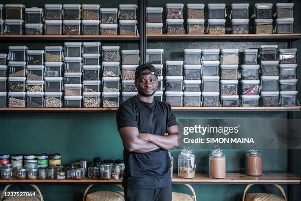 Year-old Congolese chef Dieuveil Malonga poses inside his restaurant "Meza Malonga" in Rwanda's capital Kigali, on October 27, 2021. - Congolese chef...