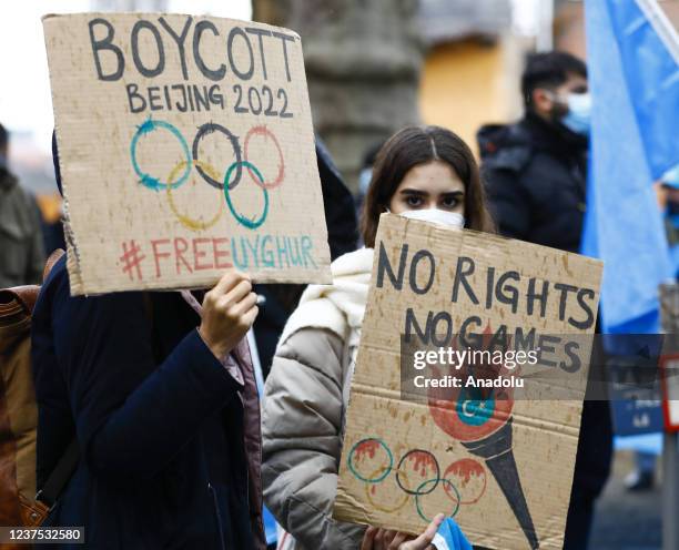 Protesters gather in front of Brandenburg Gate to stage a demonstration to call to boycott the Beijing 2022 Winter Olympic Games in Berlin, Germany...