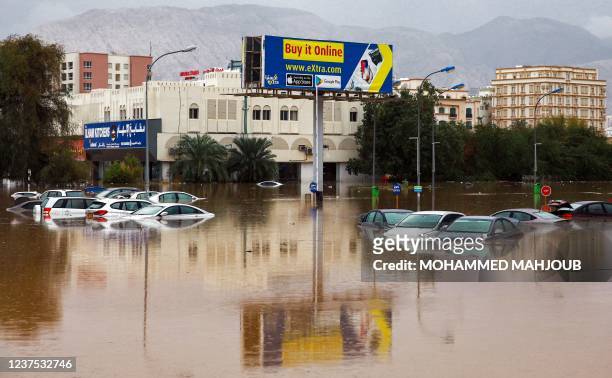 This picture taken on January 4, 2022 shows a view of completely flooded cars in a parking lot outside a shopping centre in Oman's capital Muscat. -...