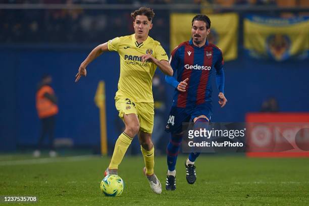 Carlo Adriano of Villarreal CF competes for the ball with Jose Angel Gomez Campana of Levante UD during the La Liga Santander match between...