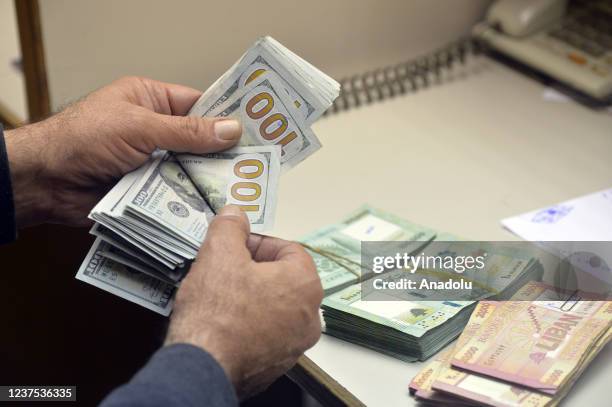 An exchange dealer shows money at a currency exchange office as the value of the Lebanese currency against the US dollar continues to drop. The...