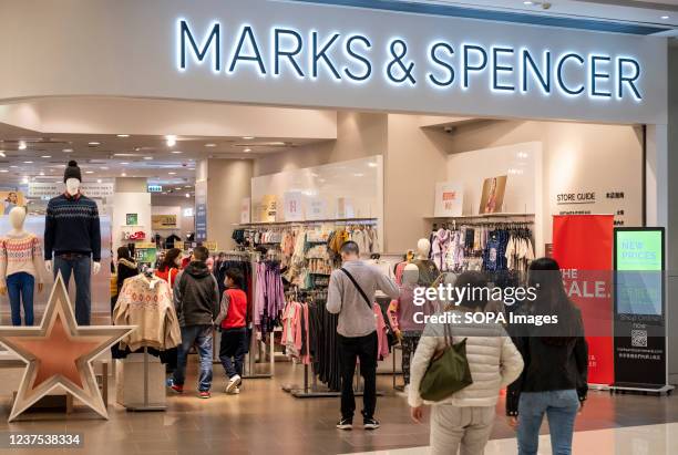 Shoppers are seen at the British multinational retailer Marks & Spencer store seen in Hong Kong.
