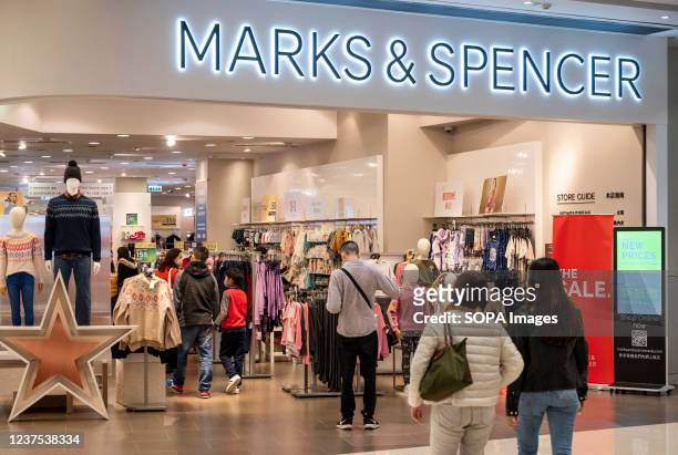 Shoppers are seen at the British multinational retailer Marks & Spencer store seen in Hong Kong.