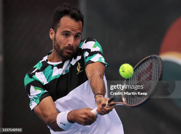 Salvatore Caruso of Italy hits a backhand during his men's singles round of 32 match against Alexandre Muller of France during day four of the 2022...