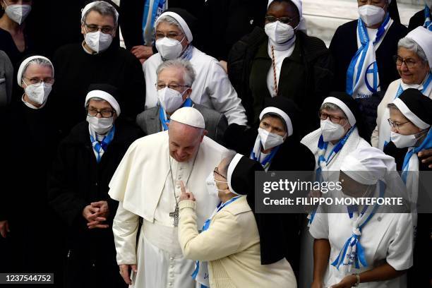 Pope Francis talks to a group of nuns during his general audience at the Paul VI Hall at the Vatican on January 5, 2022