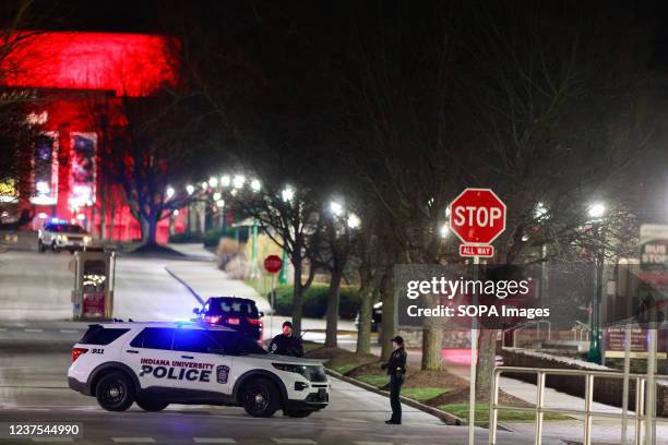 Members of the Indiana University police block a street after a homeless man who barricaded himself in a hotel room at the Indiana Memorial Union...