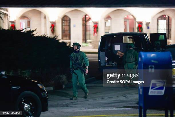 Members of the Critical Incident Response Team leave after arresting a homeless man who barricaded himself in a hotel room at the Indiana Memorial...