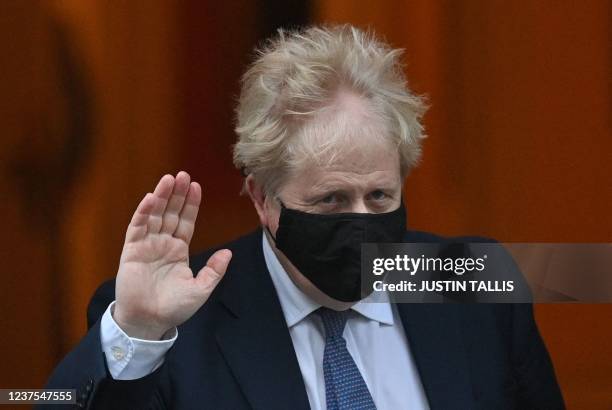 Britain's Prime Minister Boris Johnson, wearing a face covering to help mitigate the spread of coronavirus, leaves from 10 Downing Street in central...