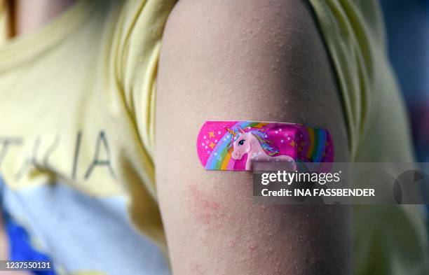 Six-year-old Hanna wears a plaster after having been inoculated with the Pfizer BioNTech vaccine for children at a vaccination centre set up at a car...