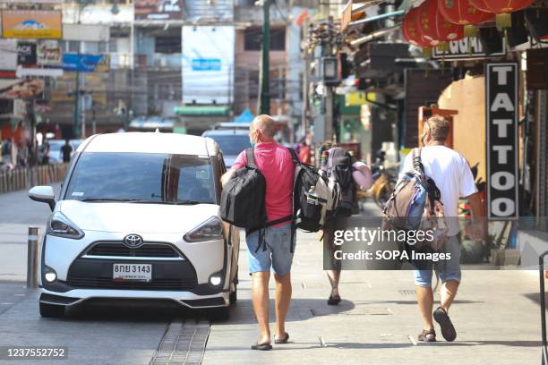 Tourists seen with their luggage on Khao San Road in Bangkok. Thailand steps up efforts to prevent the spread of the coronavirus disease , as many...