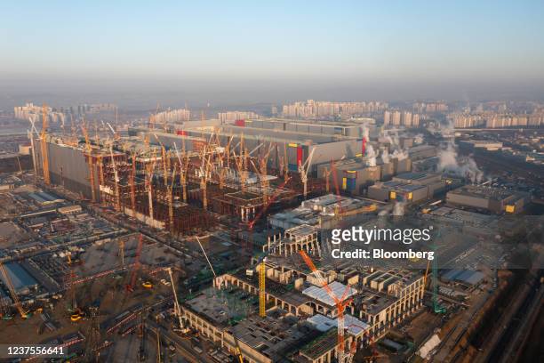 Cranes stand on a construction site at the Samsung Electronics Co. P3 semiconductor manufacturing plant, front, in Pyeongtaek, Gyeonggi Province,...