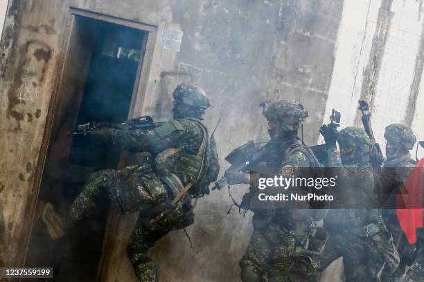 Soldiers break a door for an assault against enemies , during an Army Preparedness Enhancement Drill ahead of the Chinese New Year, amid escalating...