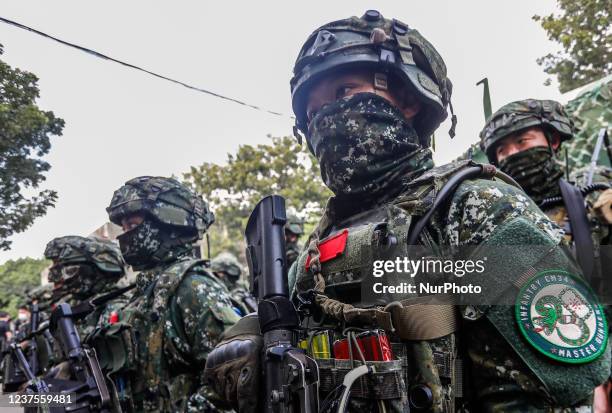 Soldiers with machine guns in procession near a CM-34 armored vehicle, during an Army Preparedness Enhancement Drill ahead of the Chinese New Year,...