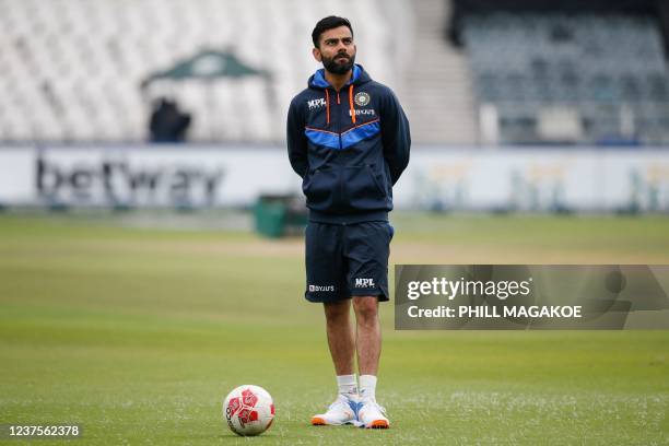 India's Virat Kohli looks on as the India team warms up ahead of the fourth day of the second Test cricket match between South Africa and India at...