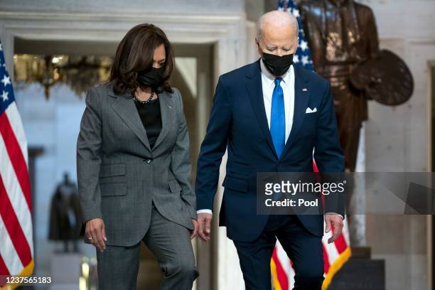 Vice President Kamala Harris and US President Joe Biden arrive to give remarks in Statuary Hall of the U.S Capitol on January 6, 2022 in Washington,...