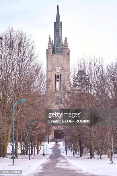 Person walks along a path in front of Middlesex College on the Campus of Western University in London, Ontario on January 6, 2022. - The University...