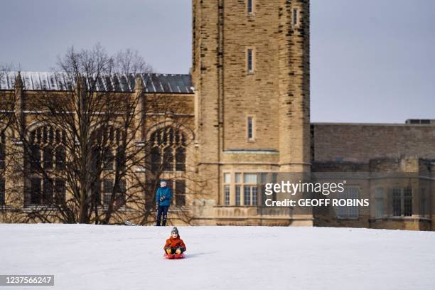Child slides down UC Hill at Western University in London, Ontario, on January 6, 2022. Ontario schools are transitioning to online learning after a...