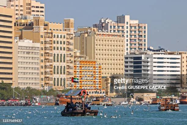 This picture taken on January 6, 2022 shows a traditional ferry boat, known as abra, used to cross the creek that separates Bur Dubai from Deira in...