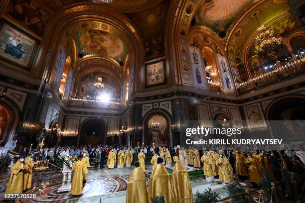Russian Orthodox believers attend a Christmas service at the Christ the Savior cathedral in Moscow, late on January 6, 2022. - Orthodox Christians...