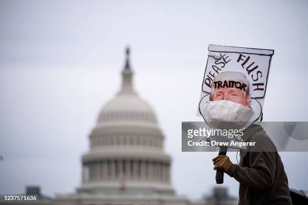 Bill Wood demonstrates with an anti-Trump sign near the U.S. Capitol on January 06, 2022 in Washington, DC. One year ago, supporters of President...